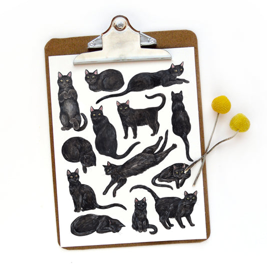 Clipboard with black cat illustrations and yellow flowers on a white background