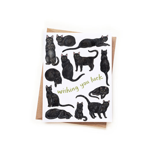 Greeting card with black cat illustrations and 'wishing you luck' text on a white background